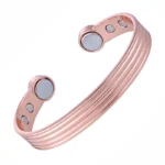 Pulseira de cobre puro - bracelete de cobre com acabamento em tom ouro rosé, design com listras horizontais em relevo e pontas arredondadas com ímãs terapêuticos embutidos - Solluss